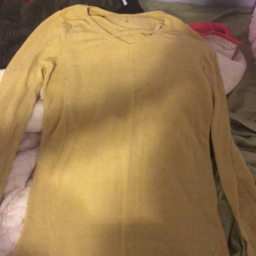 Yellow shirt, crosses in the front